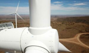 Close up of wind turbine with hot landscape behind