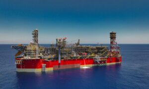Drone shot of red FPSO on a blue sea