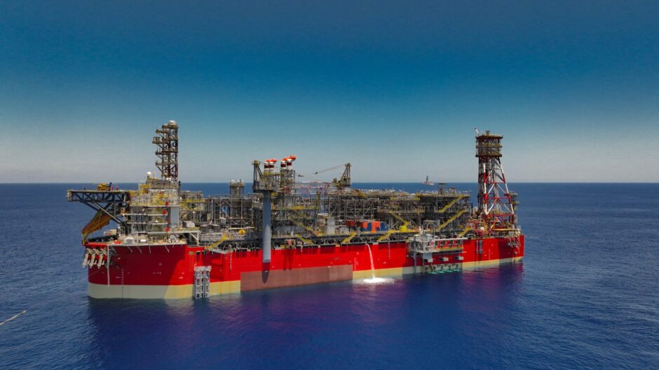 Drone shot of red FPSO on a blue sea