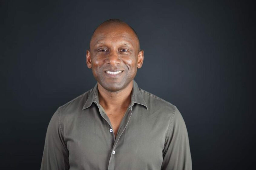 Headshot of man in grey shirt 