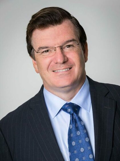 Headshot of man with blue tie