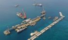 Aerial view of ships and platforms with line of caissons