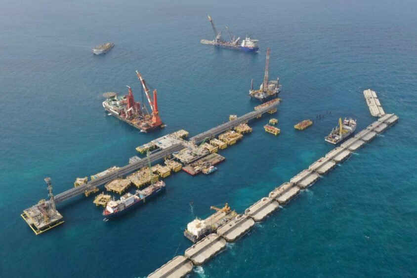 Aerial view of ships and platforms with line of caissons