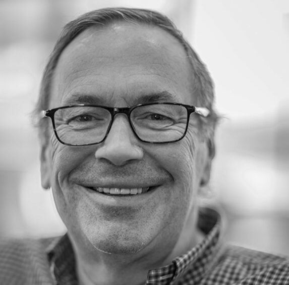 Head shot of man with glasses smiling