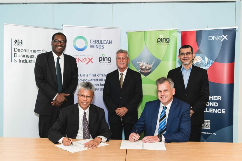 Secretary of State Kwasi Kwarteng observes the signing between Zainal Abidin Abd Jalil and Rob Fisher of Ping Petroleum with Dan Jackson of Cerulean Winds and Tan Sri Syed of DNeX.
