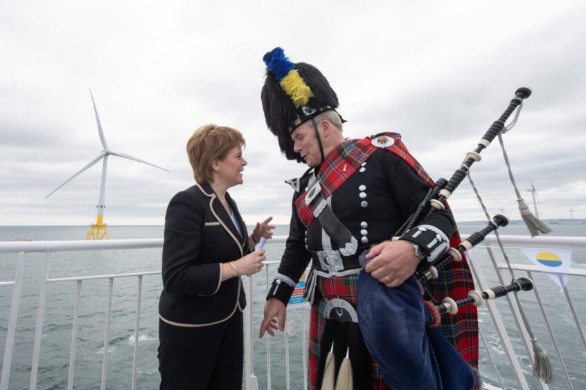First Minister Nicola Sturgeon with a piper in Aberdeen.