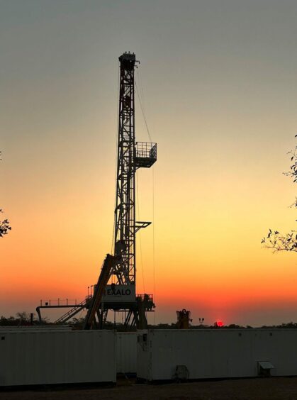 A drilling rig at sunset