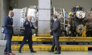 German Chancellor Olaf Scholz, center, gestures besides Christian Bruch, CEO of Siemens Energy, left, at the turbine serviced in Canada for the Nordstream 1 natural gas pipeline in Muelheim an der Ruhr, Germany, Aug. 3, 2022. German Chancellor Olaf Scholz visited a plant by Siemens Energy where a turbine, which is at the center of a dispute between Germany and Russia over reduced gas supplies, is currently sitting in storage until it can be shipped to Russia.