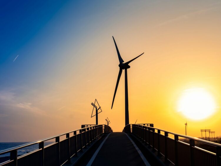 Shiosaibashi Bridge on a bicycle path and a windmill for wind power generation at the mouth of the Kikukawa River in Kakegawa City, Shizuoka Prefecture at dusk.