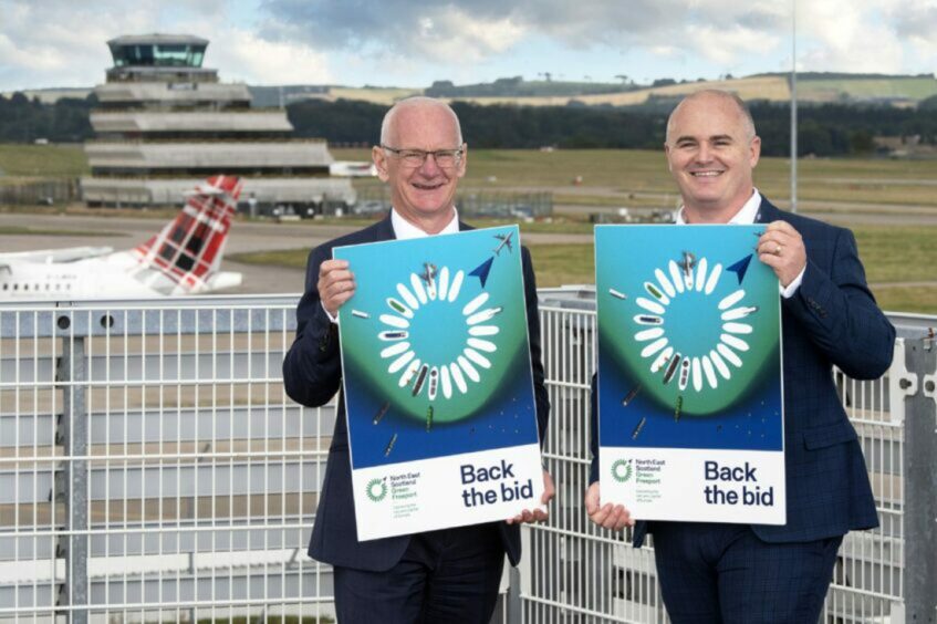 Steve Murphy, chief commercial officer at Storegga and Jon Matthews, group head of capital and planning at Aberdeen International Airport holding Back the bid posters.