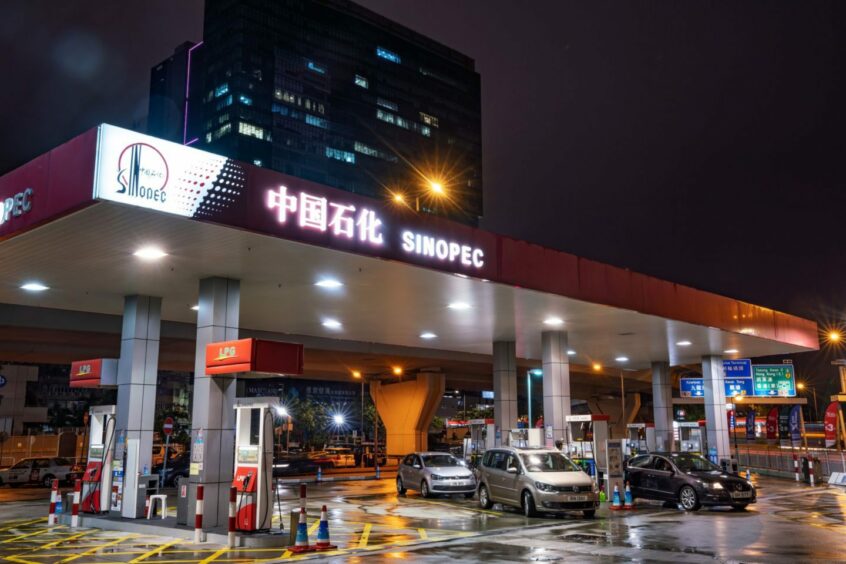 Vehicles refuel at a China Petroleum & Chemical Corp. (Sinopec) gas station at night in Hong Kong, China, on Saturday, March 23, 2019. Sinopec aims to raise spending to the highest since 2014, joining state-owned peers in their mission to churn out more domestic oil and gas to ease China's reliance on imports.