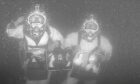 The two divers were pictured at Dalton Offshore Sweet Gas Field, about 35 5metres below the sea's surface.