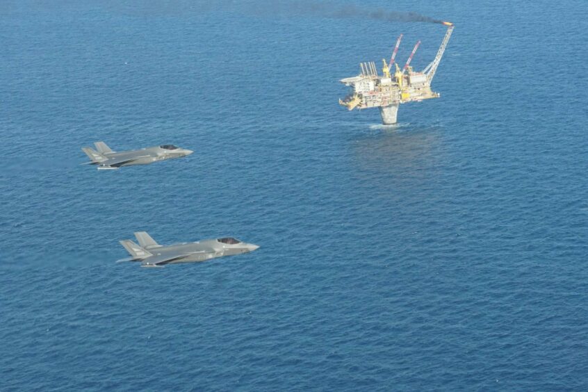 Norwegian Air Force F-35 jets pass a platform on the Norwegian continental shelf.