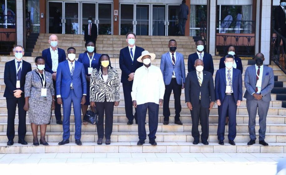 Group of people in masks stand on steps