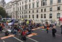 Demonstrators sit in the road outside Downing Street