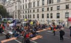 Demonstrators sit in the road outside Downing Street