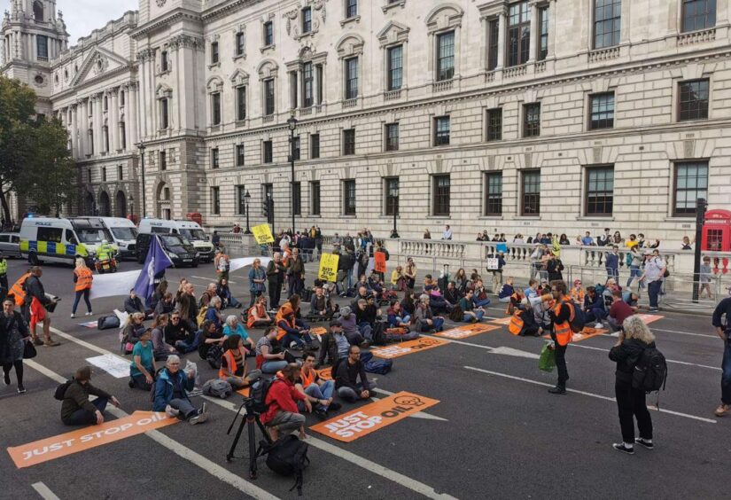 Demonstrators sit in the road outside Downing Street