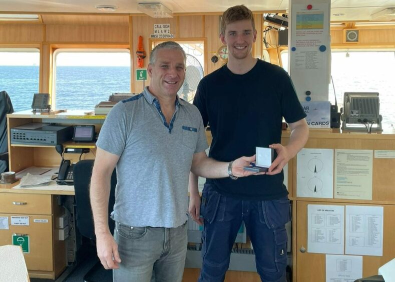 (Left to right) North Star second officer Leszek Fiedoruk and cadet Lewis McGougan receiving 'Gold Coin for Safety' awards as part of a monthly crew recognition scheme.