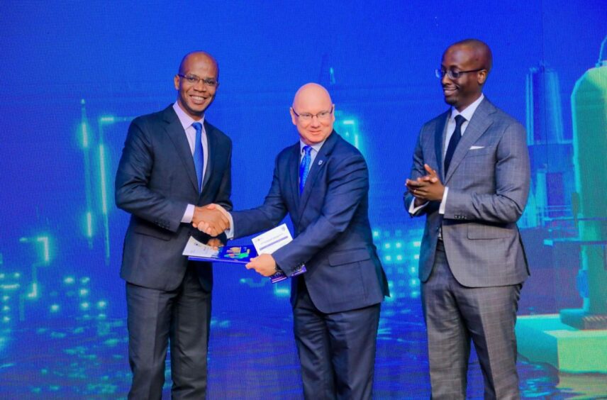 Three men in suits with blue backdrop