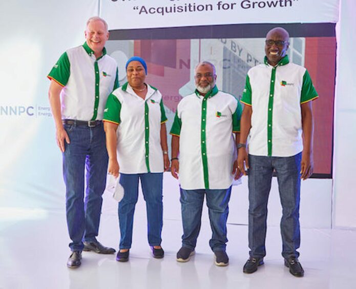 Four people in NNPC shirts