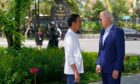 Joe Biden with Joko Widodo at a tree planting event at the Taman Hutan Raya Ngurah Rai Mangrove Forest, on Nov. 16. Photographer: Alex Brandon/AFP/Getty Images