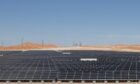 Solar panels in the desert under sunshine