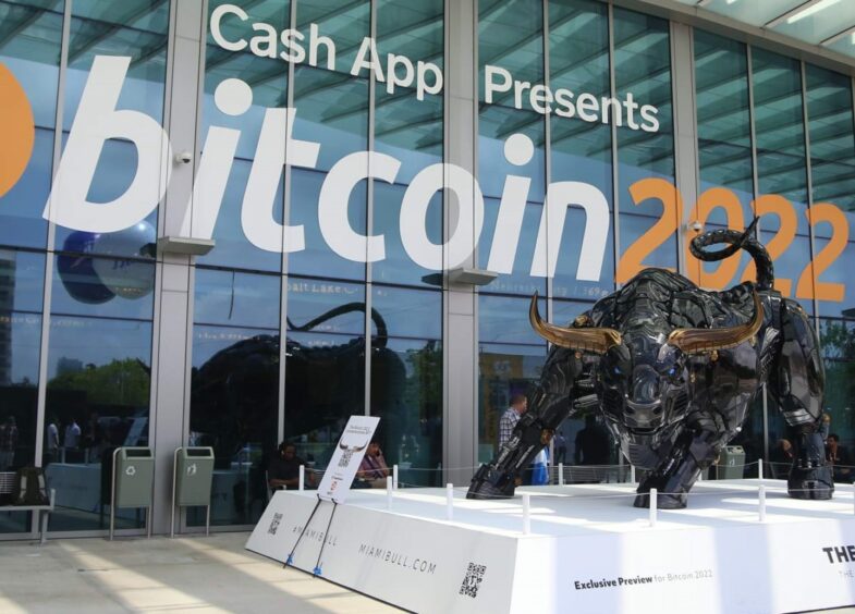 Bull in front of "bitcoin 2022" sign