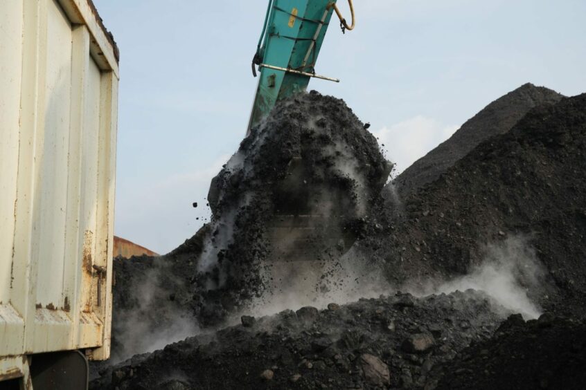An excavator loads coal onto a dump truck at Cirebon Port in West Java, Indonesia, on Wednesday, May 11, 2022. . Photographer: Dimas Ardian/Bloomberg