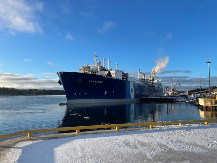 FSRU under blue sky, with ice and snow in front on ground