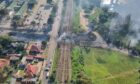 Aerial shot of rail line and bridge, with smoke