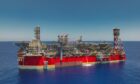 Red FPSO in blue waters on a sunny day
