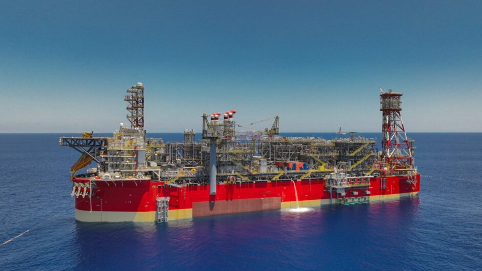 Red FPSO in blue waters on a sunny day