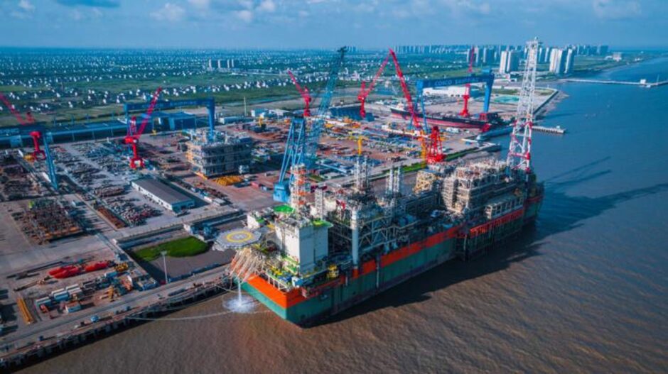 FPSO moored at a dock in sunshine, seen from an aerial view