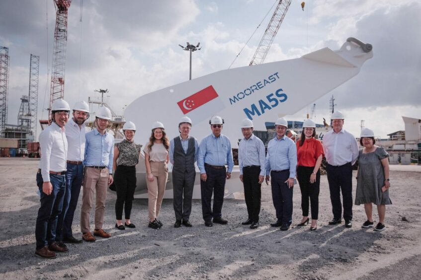 Scottish trade minister Ivan McKee and ETZ Ltd offshore renewables director Andy Rodden with Mooreast staff following the signing in Singapore.