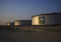A company logo sits on the side of a crude oil storage tank at the Juaymah tank farm at Saudi Aramco's Ras Tanura oil refinery and oil terminal in Ras Tanura, Saudi Arabia, on Monday, Oct. 1, 2018.