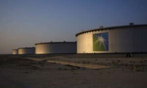 A company logo sits on the side of a crude oil storage tank at the Juaymah tank farm at Saudi Aramco's Ras Tanura oil refinery and oil terminal in Ras Tanura, Saudi Arabia, on Monday, Oct. 1, 2018.