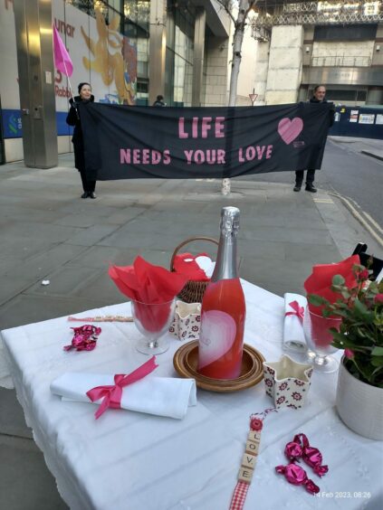 Extinction Rebellion romantic table for two set up outside the front door of Standard Chartered.