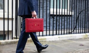 The Chancellor Jeremy Hunt walks outside Downing Street with the Budget box.