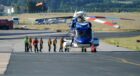Offshore workers board a Bond helicopter at Aberdeen International Airport.