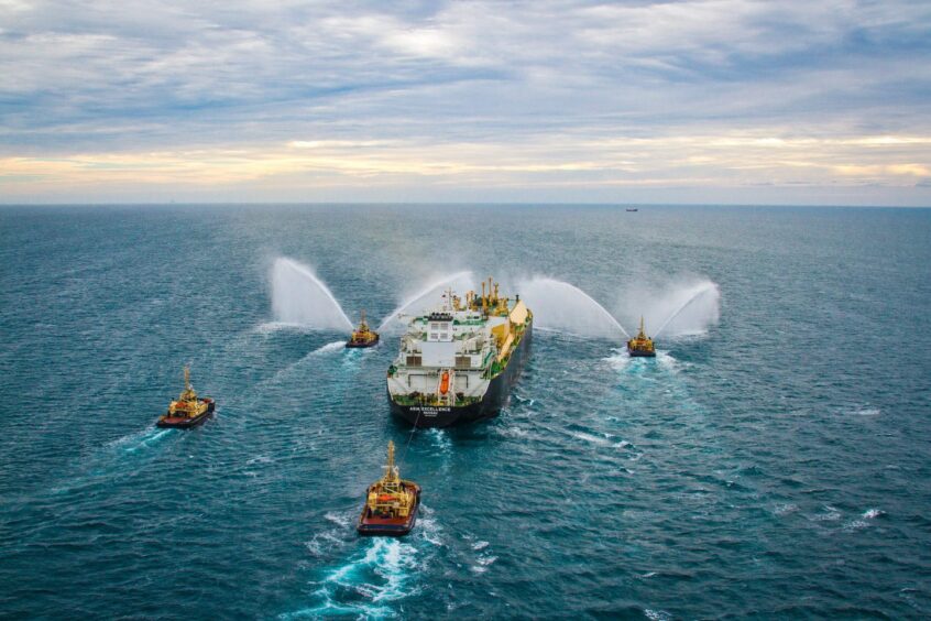 LNG carrier being sprayed by tugs