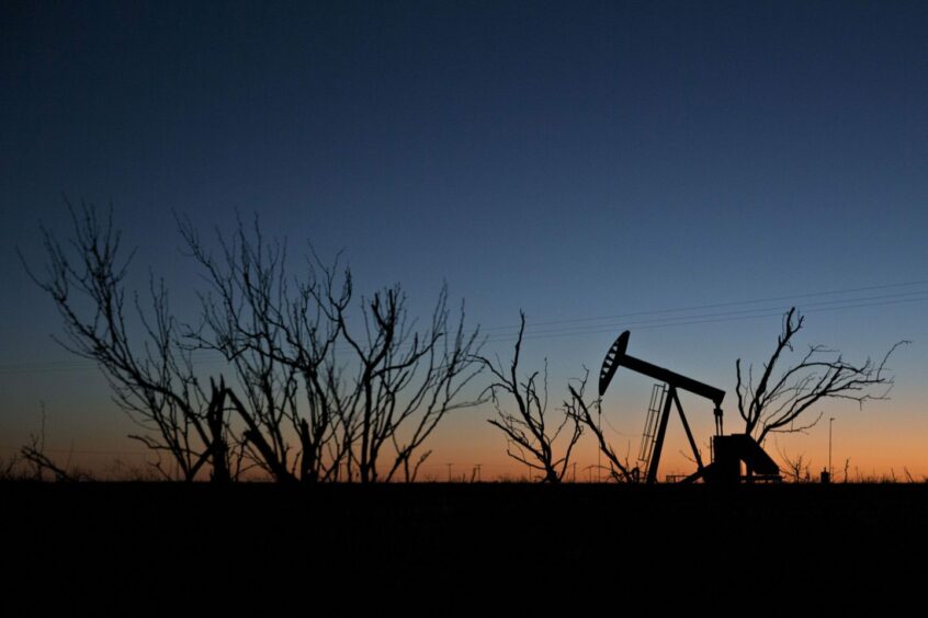 The silhouette of a pumpjack is seen at dusk in the Permian Basin in Texas, U.S. Photographer: Bloomberg Creative Photos/Bloomberg