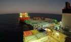 Dawn on an FPSO, a group gathers on the helideck