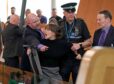 Police and security officers remove a protester from the chamber during First Minster's Questions (FMQ's) at the Scottish Parliament in Holyrood, Edinburgh. Andrew Milligan/PA Wire