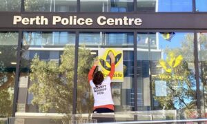 Activist spray paints Woodside logo on police station
