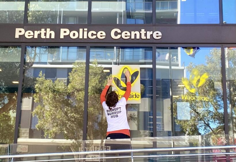 Activist spray paints Woodside logo on police station
