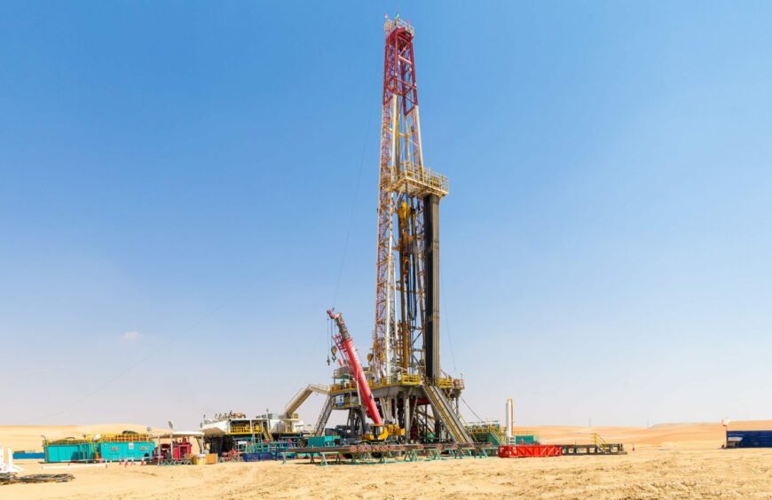 An Adnoc Drilling land rig in the desert