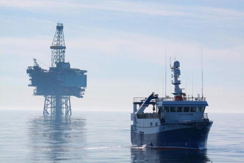 A ship with an oil platform in the background. North Sea