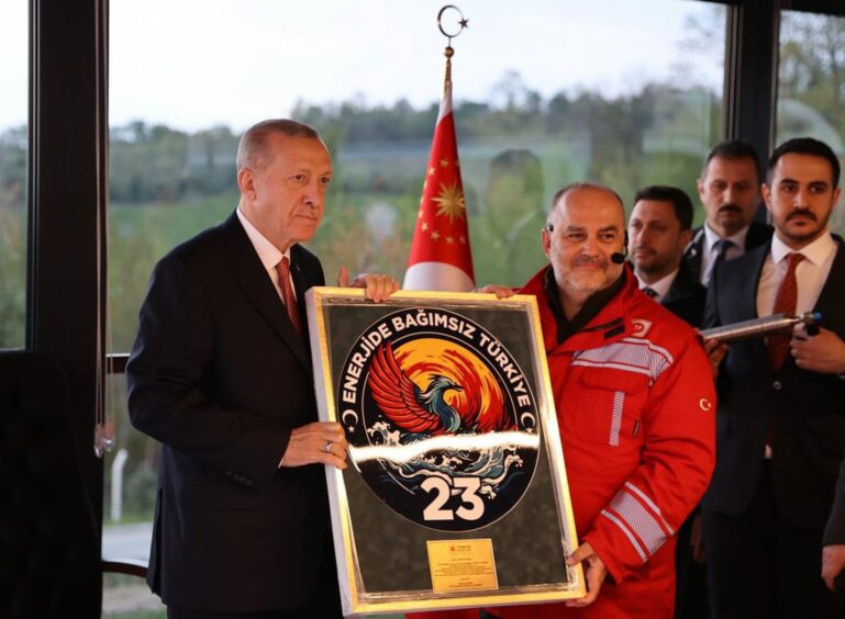 President Erdogan and TPAO official hold plaque