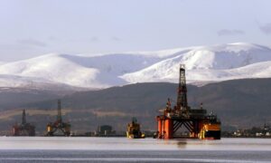 The oil platform Stena Spey is moved with tug boats amongst other rigs in the Cromarty Firth near Invergordon in the Highlands of Scotland.