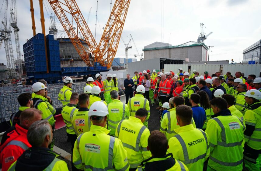 Labour leader Sir Keir Starmer (centre) talking to workers during a visit to Hinkley Point nuclear power station in Somerset
